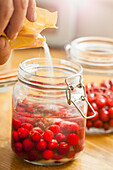 Adding Sugar to Cherries in Mason Jar