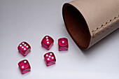 Still life red dice and leather cup on white background