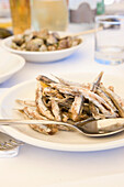 Grilled Anchovies on white plate