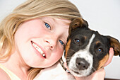 Girl Hugging Jack Russell Puppy