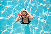 Elevated view of a woman standing in a swimming pool