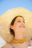 Close up of a woman wearing a straw hat
