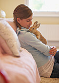 Girl Sitting and Holding Rabbit