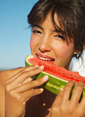 Junge Frau isst eine Wassermelone