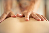 Close up massage therapist massaging back