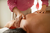 Close up man receiving shoulder massage in spa