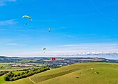 Paragliders at Mount Caburn, flying over the County town of Lewes, East Sussex, England, United Kingdom, Europe