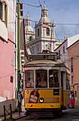 Trams and tourist buggies in the Alfama old town area of Lisbon, Portugal, Europe