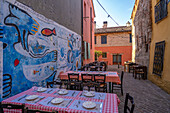 Blick auf bunte Restauranttische im Borgo San Giuliano, Rimini, Emilia-Romagna, Italien, Europa