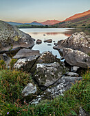 Rocks and lake at sunrise, Llynnau mymbyr, Capel Curig, Snowdonia National Park, Wales, United Kingdom, Europe