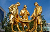The statue of Matthew Boulton, James Watt and William Murdoch known as The Golden Boys, Centenary Square, Birmingham, West Midlands, England, United Kingdom, Europe