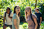 Two women looking up during hiking excursion