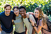 Portrait of small group of friends looking at the camera during hiking excursion