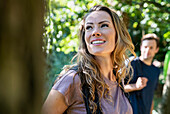 Adult woman hiking with boyfriend in the woods