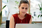 Businesswoman working on laptop at office