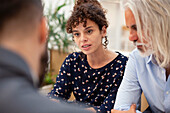Adult woman discussing with partner and lawyer during meeting