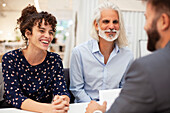 Adult couple smiling while having a meeting with lawyer