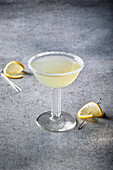 Lemon cocktail on a grey background