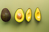 Sliced avocado on a plain background