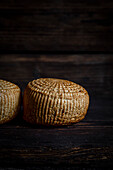 Smoked cheese against a a dark background with copy space