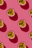 Vertical pattern of tropical exotic passion fruit on pink background flatlay food