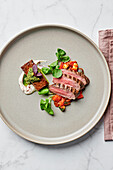 Grilled rack of lamb, pressed lamb shoulder, honey-lemon yoghurt, summer ratatouille, coriander-walnut salsa, chickpea sprouts