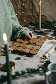 Baking Christmas almond butter biscuits with candlelight in an atmospheric style
