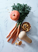 Top view with autumn orange produce. Carrots, pumpkin, butternut squash