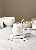 Cashew cream with spoon on marble surface