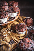 Homemade chocolate muffins with cholcolate chips in a rustic kitchen