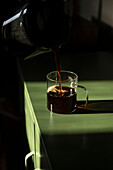Coffee in glass cup on green table