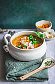 Red lentil and sweet potato soup, served in a white bowl