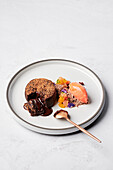 Warm chocolate fondant, Cointreau citrus segments, gianduja snow, blood orange sorbet