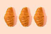 Croissant pattern over pink background