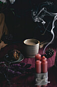 English afternoon tea with muffin and candles in an atmospheric and dark style