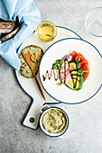 Healthy lunch from above with vegetable salad and toast with walnut paste