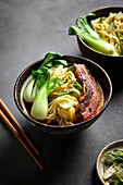 Ramen, Pork Belly and Bok Choy with a Black Background