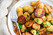 Roasted spring potato with fresh dill cabbage and raw vegetable salad served in a bowl