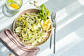 Top view of healthy celery salad with apples and seeds served in the bowl on concrete background