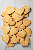 Cut-out biscuits in the shape of a heart on a marbled background