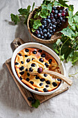 red grape clafoutis, French cuisine. on a table made of ceramic tiles with a blue pattern.
