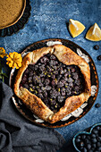 Blueberry and blackberry galette on a blue background