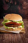 Vegan burger with vegetable patty on a wooden background