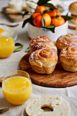 Breakfast tablescape with pastries, orange juice and fruit