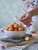 Doughnuts in a bowl on a napkin and a cutting board