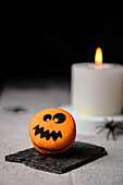 Jack o lantern macaron over table for Halloween