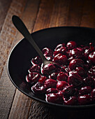 Cherry compote in a black bowl