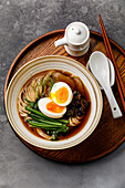 Ramen, Asian noodles in broth with beef tongue, mushrooms and eggs in a bowl