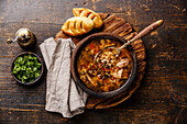 Traditional Georgian soup kharcho with meat and rice on a wooden base