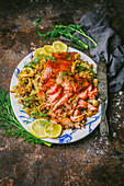 Glazed salmon and roasted fennel on serving platter with lemon and fennel frond garnish